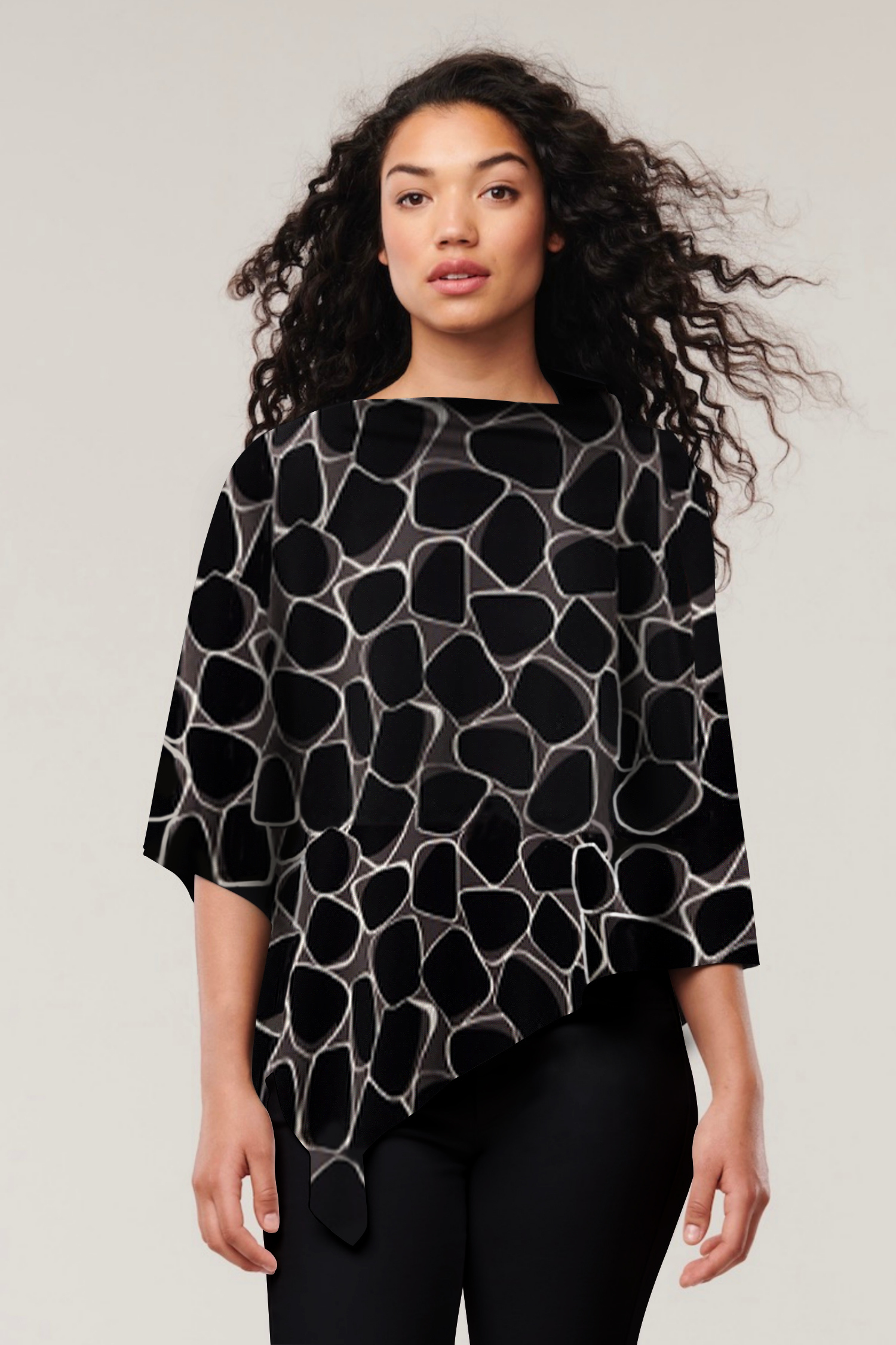 Helene Clarkson Design Nadi 8-in-1 travel wrap scarf featuring geometric patterns in neutral tones.