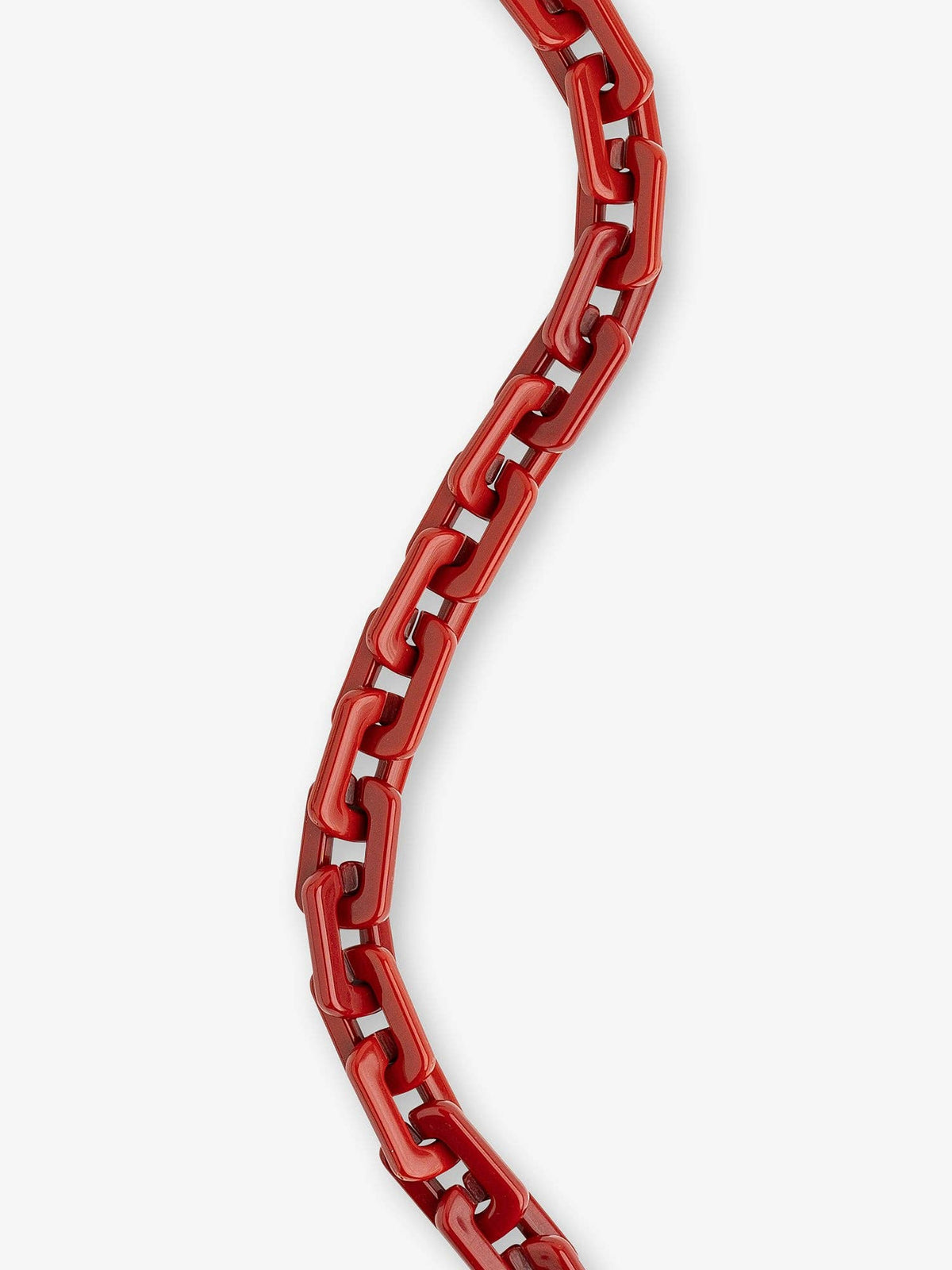 A close-up of a glossy red chain necklace or strap curving vertically against a plain light gray background.