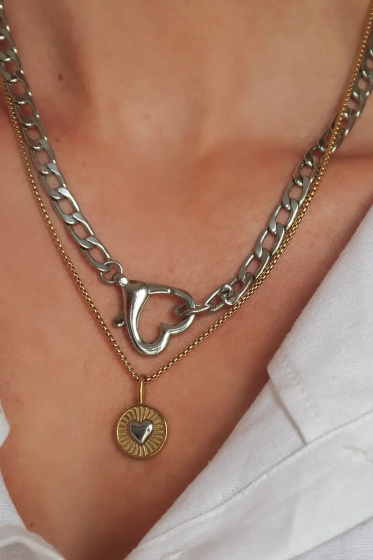 Gold Saiba Heart Clasp Necklace by Namaste Jewelry featuring a delicate shell pendant and secure clasp, elegant jewelry accessory.