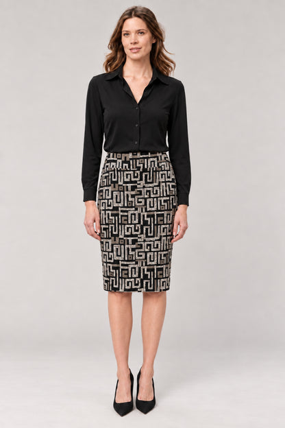 A woman modeling a black long-sleeve button-up shirt and a black-and-white geometric patterned pencil skirt, paired with black high heels, against a light gray studio background.