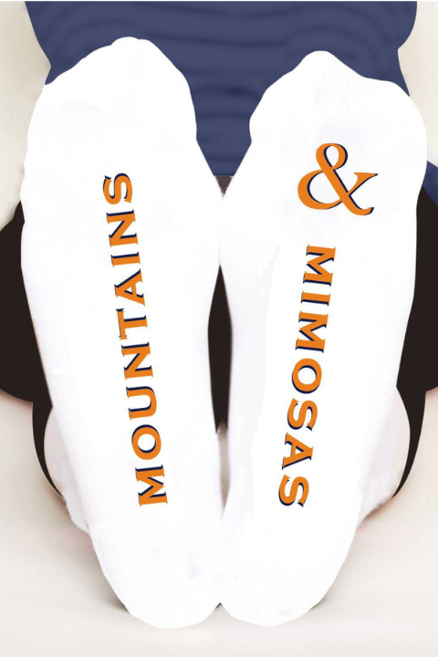 Colorful Toss Designs socks featuring mountain and mimosa floral patterns, perfect for casual wear.