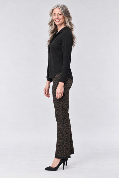 A model wearing a strapless beige and brown graphic print dress with a tiger print bodice, a matching high-waisted skirt, and a long sheer draped overlay, paired with white platform sandals, on a light gray background.